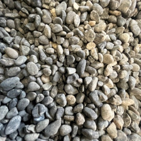Close-up of small pebbles in various shades of gray and brown.